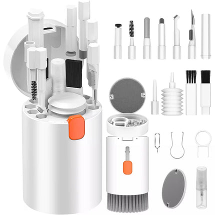 A white cylindrical makeup brush cleaner set shown open with multiple interchangeable brush and applicator heads, plus several small accessory tools arranged on a plain white background.