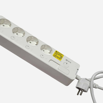 White power strip with multiple sockets on a white background