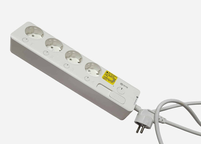 White power strip with multiple sockets on a white background