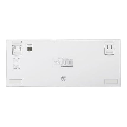 The underside of a white mechanical keyboard showing the port layout, USB-C port, label sticker, and rubber feet on a solid white background.
