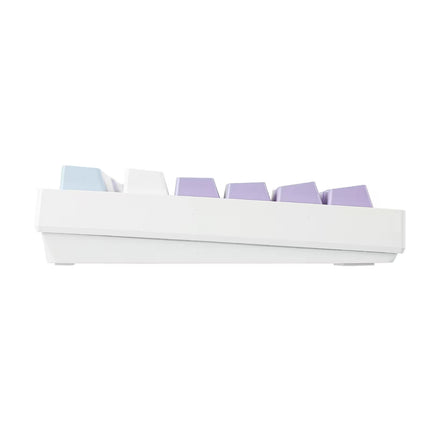 A white mechanical keyboard switch tray holding several pastel-colored keycaps in light blue, white, and lavender purple, shown against a solid white background.