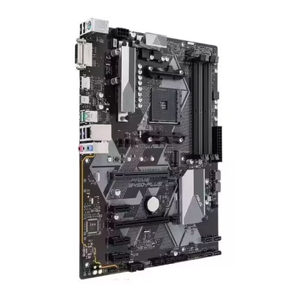 Angled view of the ASUS PRIME B450-PLUS motherboard showcasing the AM4 CPU socket, PCIe expansion slots, DDR4 DIMM slots, M.2 connectors, and silver heatsinks in a clean black PCB layout.