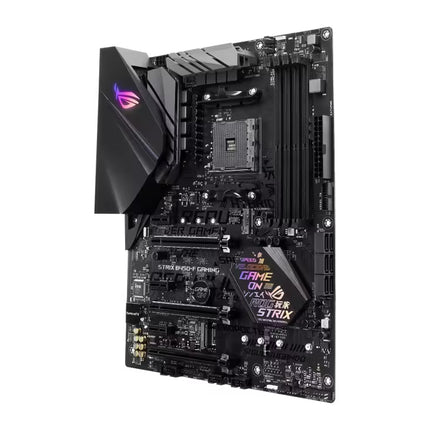 ASUS ROG Strix B450-F Gaming Motherboard in black with RGB lighting accents and gold-plated gold-plated pins, shown at an angle on a white background.