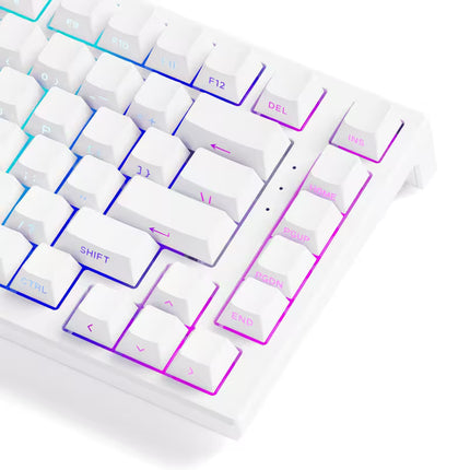 Close-up of a white keyboard with colorful backlighting on a white background