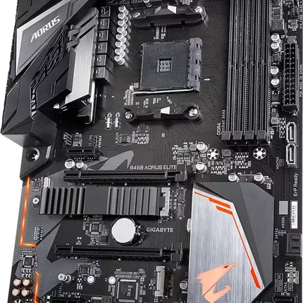 A Gigabyte AORUS B450E ELITE motherboard photographed from an overhead angle on a plain white background. The board is predominantly black with large silver heat sinks and orange accent lines and logos.
