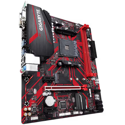 Angled product shot of a Gigabyte B450M GAMING micro-ATX motherboard, highlighting its black and red PCB design, AM4 CPU socket, and armored PCIe slot.