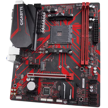 Full view of the Gigabyte B450M GAMING micro-ATX motherboard from a high angle, displaying the VRM heatsink with Gigabyte branding and the distinct red accent lines on the PCB.