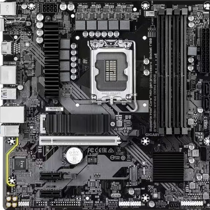 A top-down view of a Gigabyte LGA1200 desktop motherboard with a black PCB, silver CPU socket, and multiple black and silver components and heatsinks.