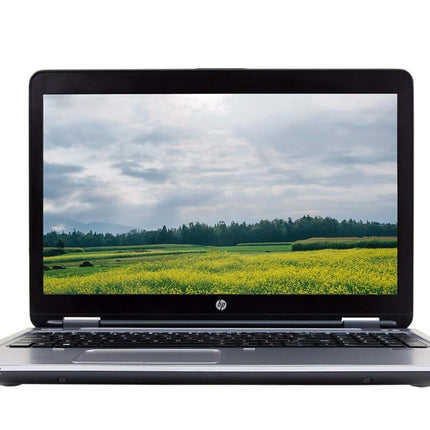 Laptop displaying a scenic view of a field on its screen