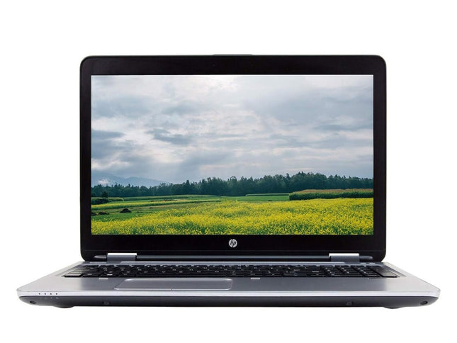 Laptop displaying a scenic view of a field on its screen