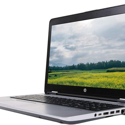 Laptop displaying a scenic view of a field on its screen