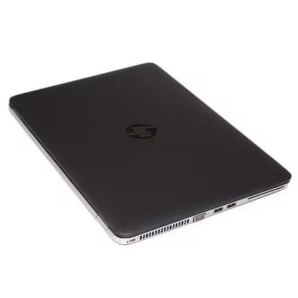 A closed black HP laptop shown from an elevated angle, displaying the top lid with the HP logo and the silver edge of the chassis.