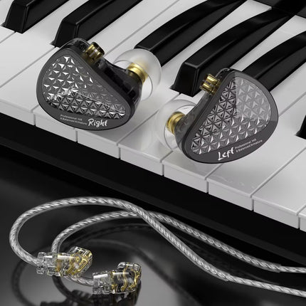 Pair of in-ear monitors on a piano keyboard with a clear cable.