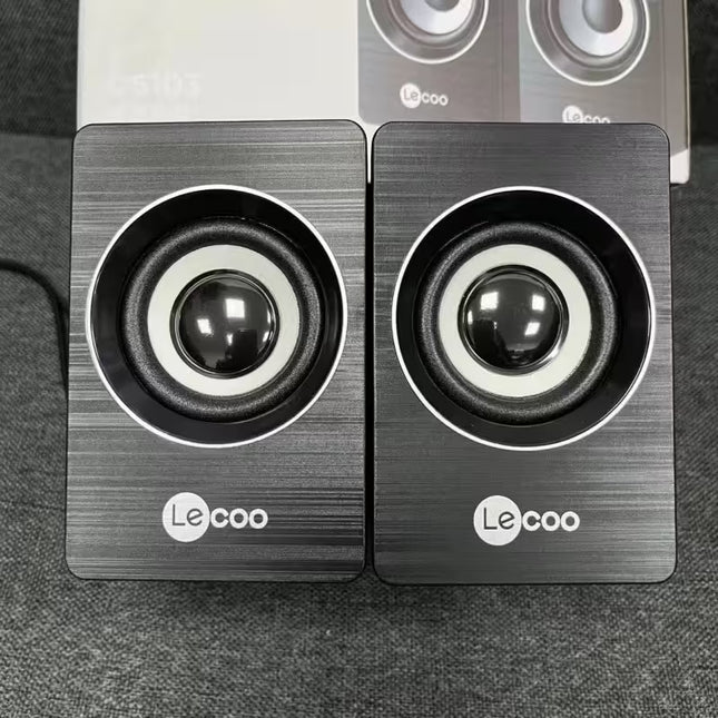 Pair of Lecoo speakers on a dark surface