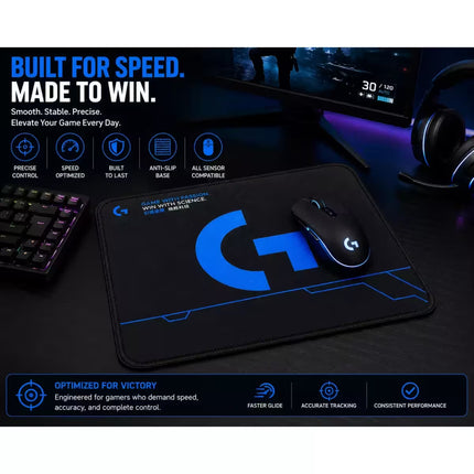 Logitech gaming mouse pad with a large blue G logo and glowing blue lines, shown with a black and blue Logitech mouse on a dark desk setup. The image includes marketing text and icons highlighting features like precise control, speed optimization, and anti-slip base.
