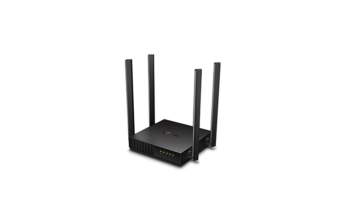 Black router with four antennas on a white background
