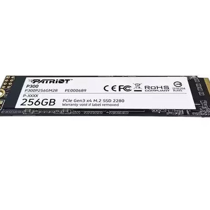 Low-angle view of the Patriot P300 256GB M.2 2280 NVMe SSD showing its slim profile, black PCB, white product label, and gold M.2 edge connector.