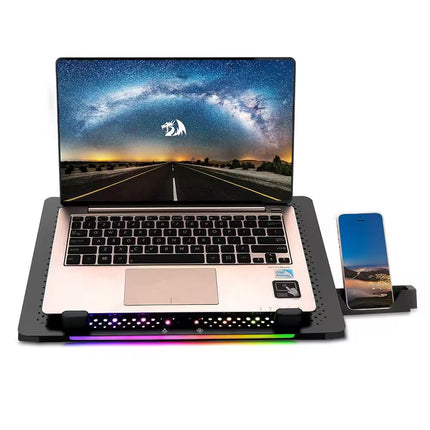 Laptop on a cooling pad with RGB lighting, displaying a scenic wallpaper.
