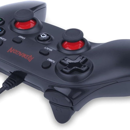 Black gaming controller with red buttons on a white background