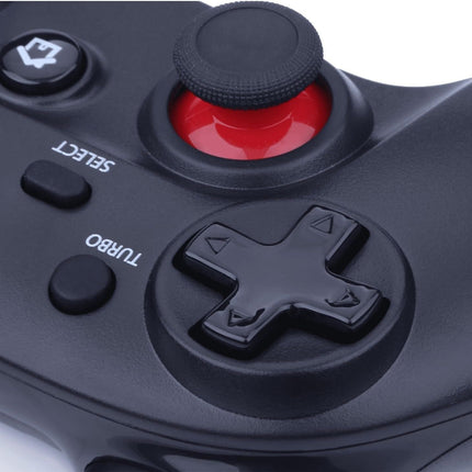 Close-up of a black gaming controller with a red joystick on a white background
