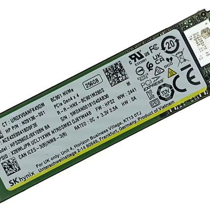 An SKHynix M.2 NVMe solid state drive with a green PCB and a large white label containing specifications, barcodes, and regulatory marks, with a gold-plated connector on the right.