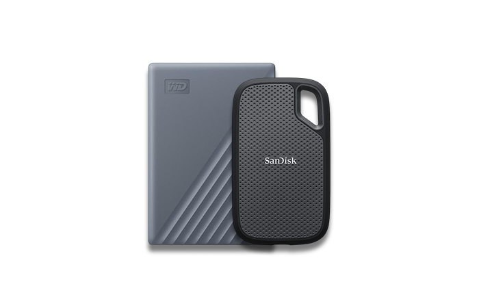 Two external hard drives, one gray and one black, on a white background.