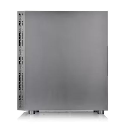 A matte dark gray computer case shown from the front, featuring ventilation grilles on the left side and small feet at the bottom, set against a plain white background.