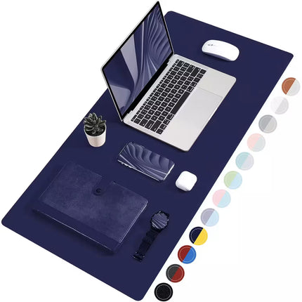 A large navy desk mat laid out on a white background, styled with a laptop, mouse, notebook, plant, and watch. A vertical row of circular color swatches appears along the right side of the mat.