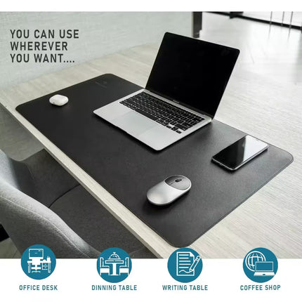 A large black desk mat on a light wood table, shown with a laptop, mouse, and smartphone placed on it. Text in the upper left reads 'YOU CAN USE WHEREVER YOU WANT.