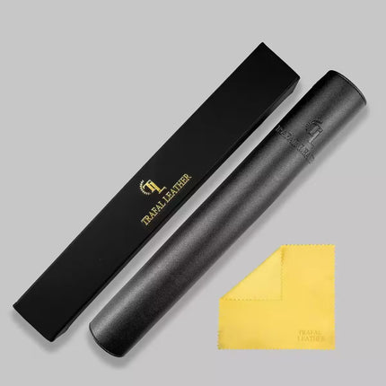 A black leather cylindrical accessory shown next to its black presentation box with gold 'TRAIL LEATHER' branding, plus a small yellow microfiber cloth on a light gray background.