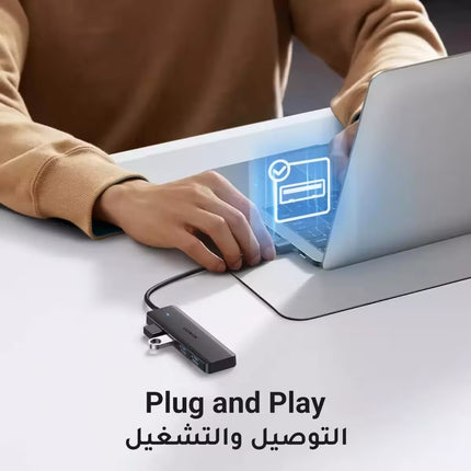 Person using a laptop with a USB adapter on a desk, featuring 'Plug and Play' text.