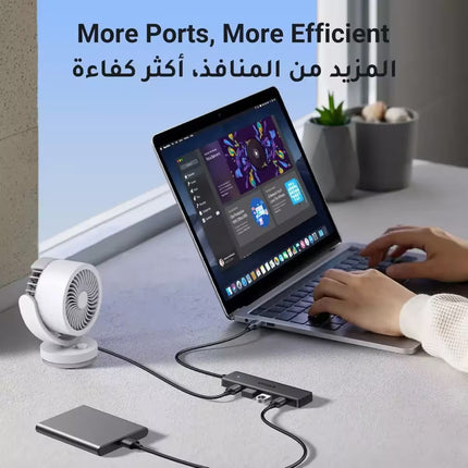 Person using a laptop with a USB hub on a desk, featuring text about more ports and efficiency.