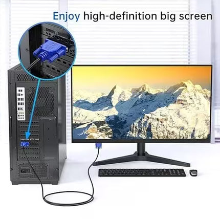 Computer setup with monitor displaying mountain landscape, tower, and keyboard on a white background.