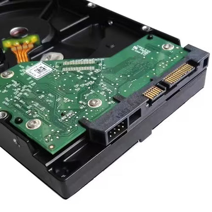 Rear view of a Western Digital Black 1TB 3.5-inch internal hard disk drive (HDD) showing the green PCB, SATA data and power connectors, and controller board