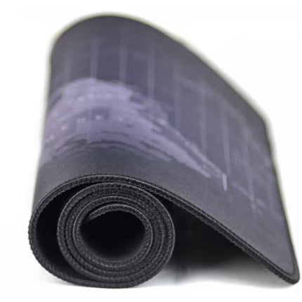 A rolled-up black gaming mouse mat with a light gray blueprint-style grid pattern, shown on a plain white background.