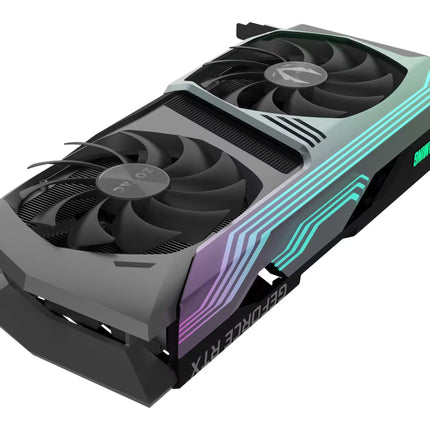 A Zotac graphics card with a black and dark gray dual-fan design, featuring green and purple RGB lighting accents on top, shown against a plain white background.