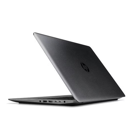 Closed HP ZBook workstation laptop viewed from an angled rear perspective, highlighting its textured metallic lid with a central HP logo and side-mounted I/O ports along the chassis.   