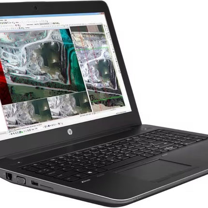 Angled perspective view of an open HP ZBook workstation laptop showing a geographic mapping and GIS software interface on the screen, a full-sized keyboard with a numeric keypad, a trackpad, and side ports including a VGA connection along the chassis.