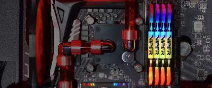 Close-up of a computer motherboard with RGB lighting and a VRM cooler.